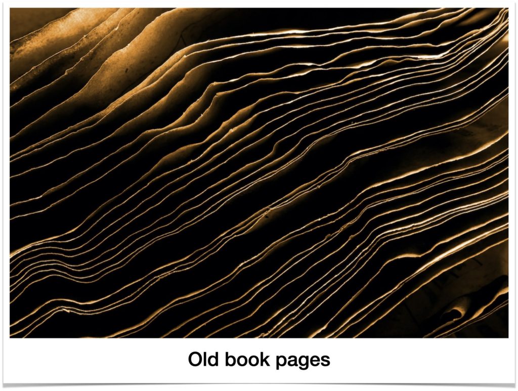 Image of old book pages fanned out to show how warped they get with use and possible water damage. They represent a visual to demonstrate why and how short nails peel faster than long nails. Nailcarehq